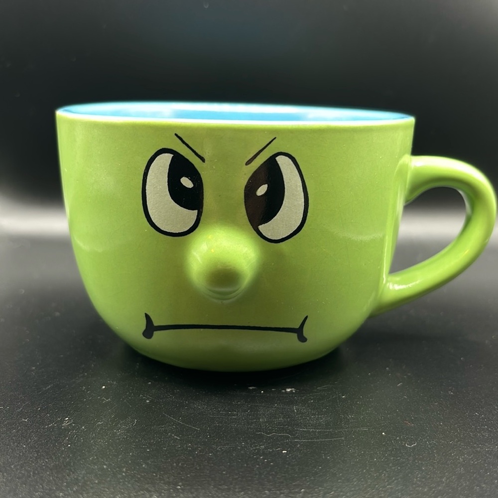 Coffee cup angry face green and blue in color